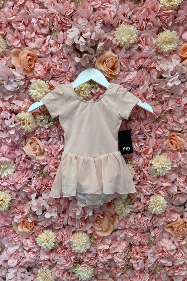 Girls Short Sleeve Light Pink Skirted Leotard Dress by Bloch CL5342 Tiffany dress at The Dance Shop Long Island